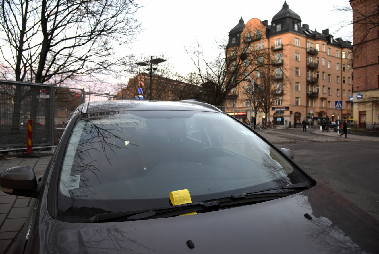 En parkeringsbot under en vindrutetorkare på en bil i Stockholm.