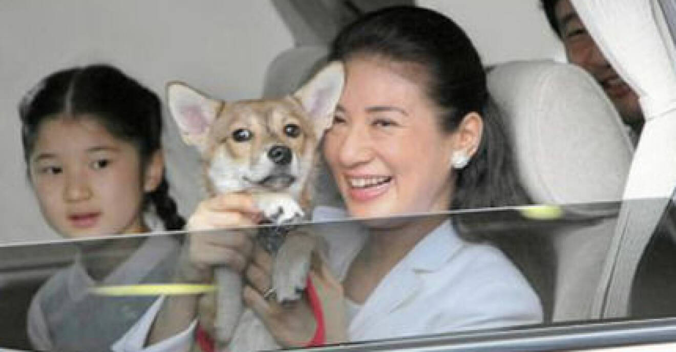 Kropnprinsessan Masako håller upp familjens hund.