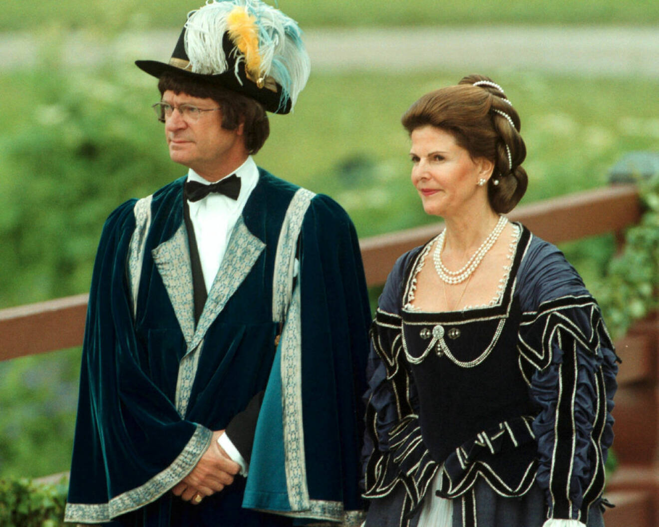 Kung Carl XVI Gustaf och drottning Silvia firar silverbröllop i svulstiga kostymer.