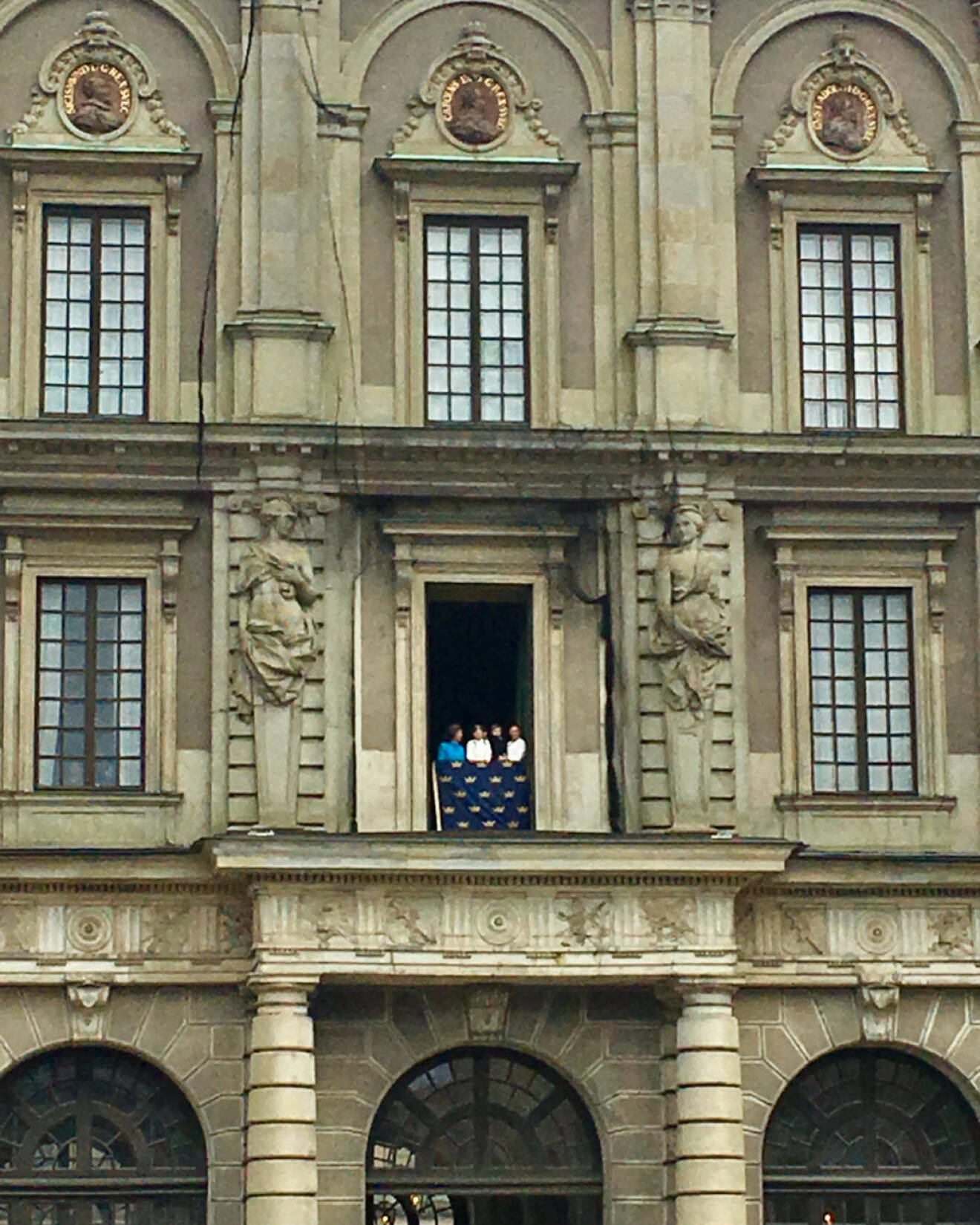 Estelle, Oscar vid fönstret med drottning Silvia, kronprinsessan Victoria, prins Daniel och prinsessan Sofia