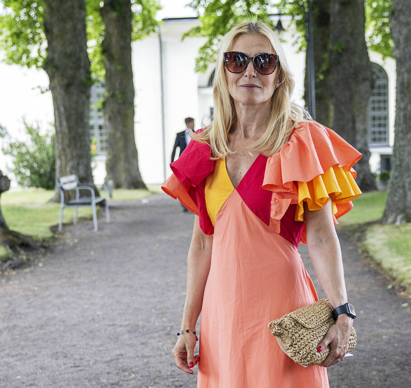 Kronprinsessan Victorias svägerska Anna Westling Söderström i orange volangklänning på Sara Westlings bröllop
