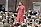 Lotta Engberg i en röd klänning under Lotta på Liseberg