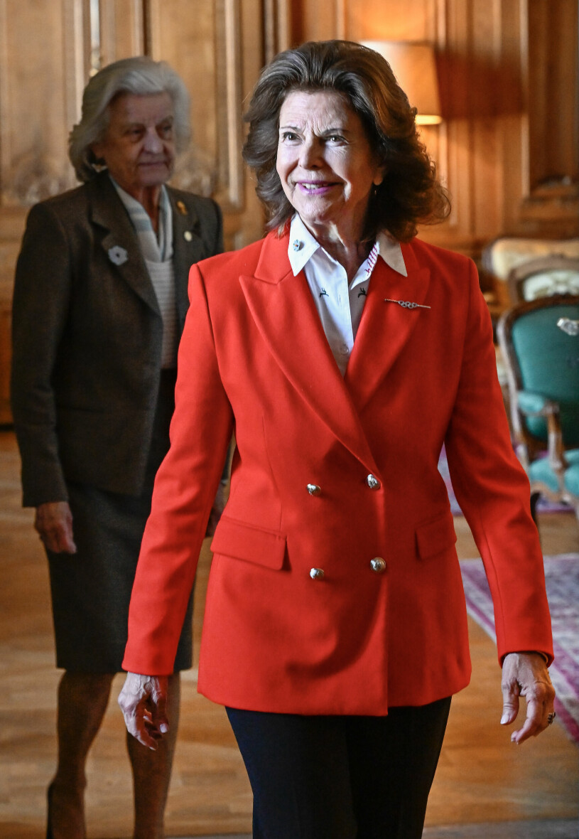 Drottning Silvia i röd kavaj vid medaljutdelning på slottet