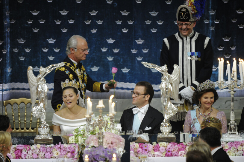 Gästerna utbrast i ett "åhhh" när kungen överräckte en ros till sin Silvia. kung Carl XVI Gustaf överräcker en ros till drottning Silvia under bröllopsmiddagen för kronprinsessan Victoria och prins Daniel under bröllopsmiddagen i Rikssalen på Slottet i Stockholm efter vigseln på lördagen.
