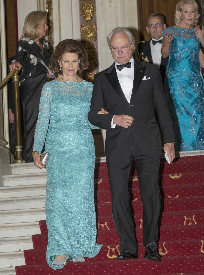 Kung Carl Gustaf och drottning Silvia i smoking respektive paljettklänning