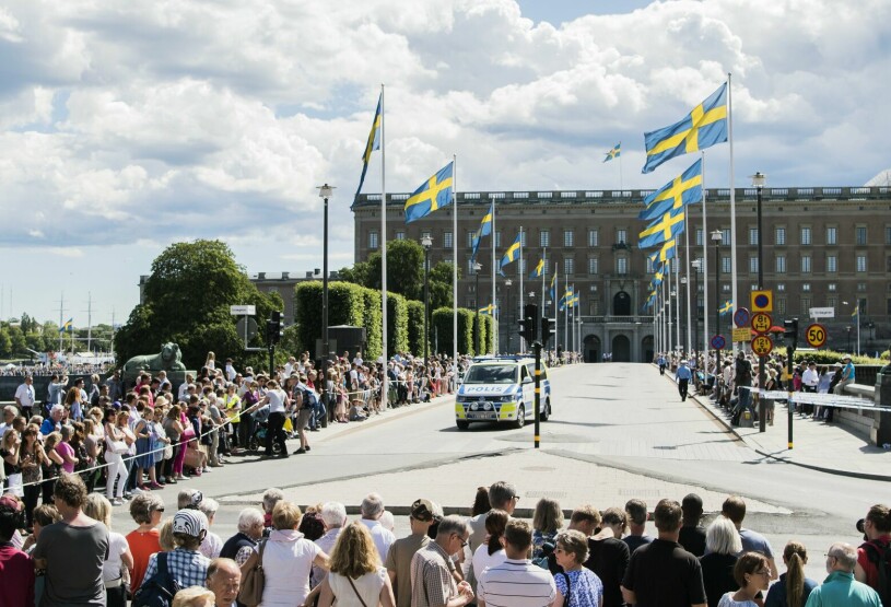 Kungen firas med kortege. Folk på Norrbro i väntan på en kunglig kortege
