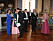 Drottning Silvia i en Korea-blå aftonklänning. Här hälsar hon på statsministern.